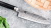 
                    Scalloped Santoku with dimples of the blade building air cushions
